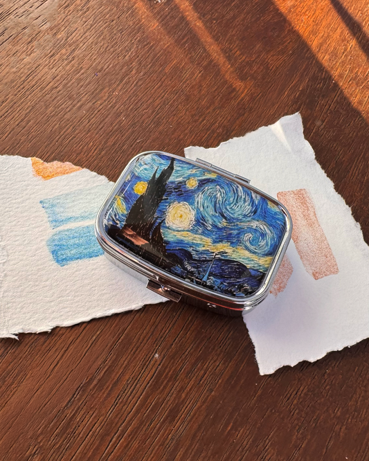 Compact mirror with Starry Night design on a wooden surface