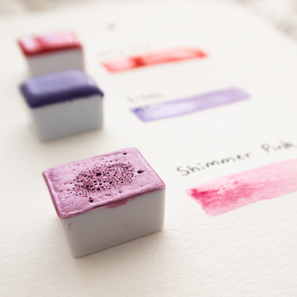 shimmery pink watercolour paint pan closeup